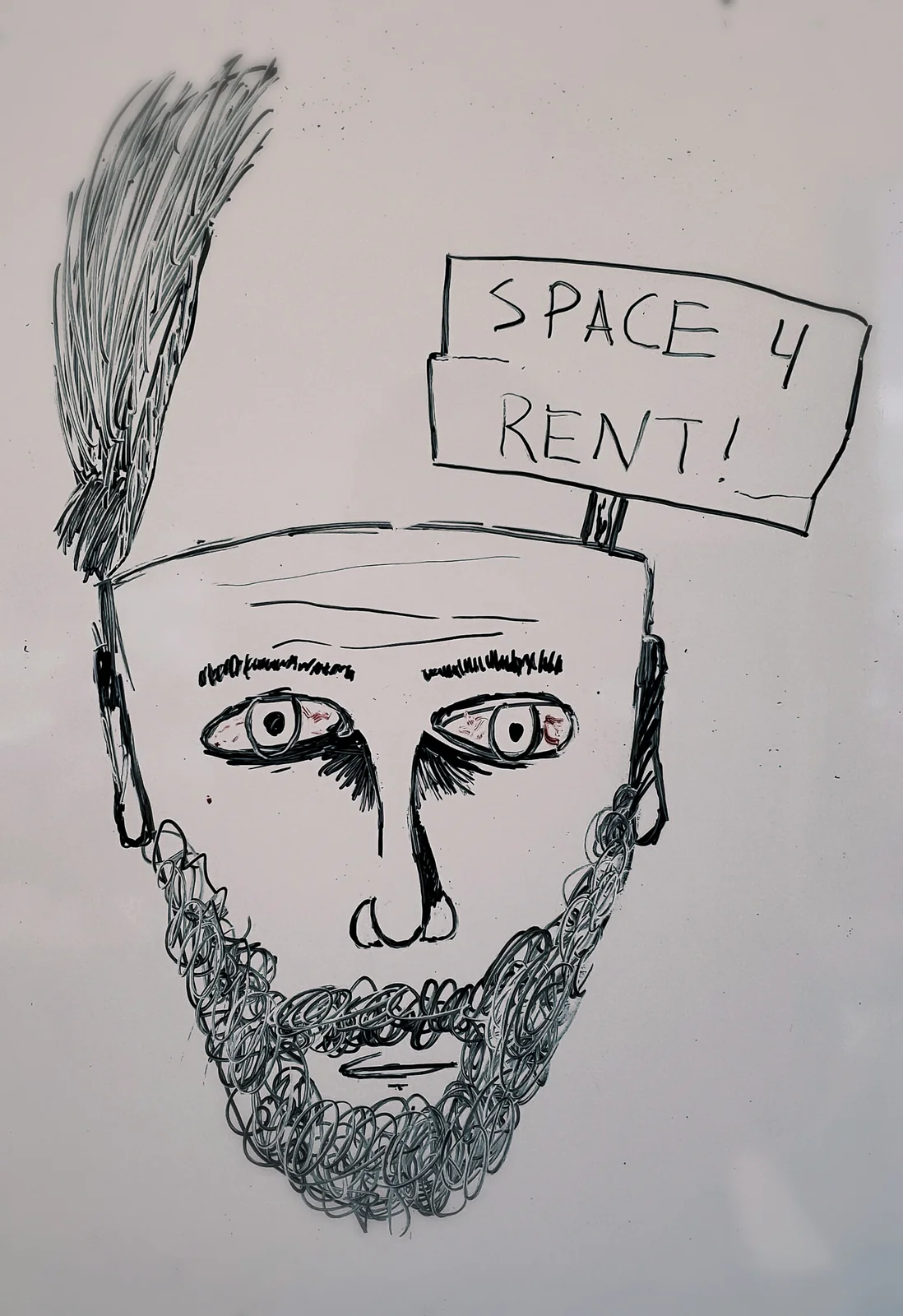 Pen drawing of a bruised-eyed bearded man holding a sign reading Space 4 Rent!